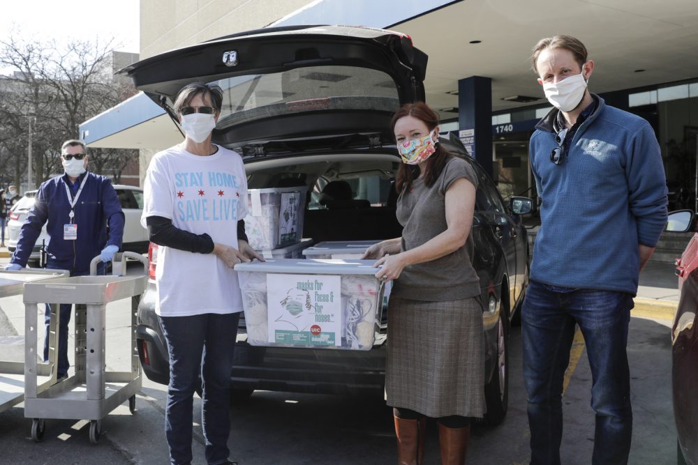 Chicago&rsquo;s First Lady Amy Eshleman, left, helps Rebecca Rugg, dean of the College of Architecture, Design and the Arts, and Chris Plevin of the Chicago Shakespeare Theater, deliver 5,000 fabric face masks to the University of Illinois Hospital on April 3.