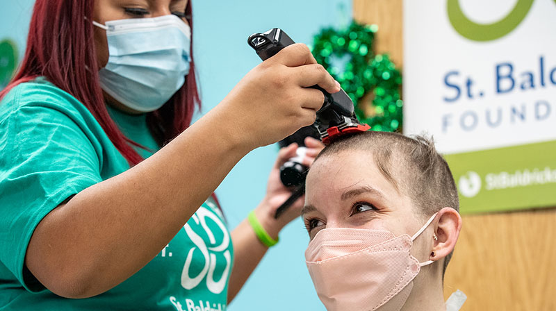 Ashley Roman, a UIC student majoring in mechanical engineering, gets her head shaved during the annual St. Baldrick&rsquo;s fundraiser at the Children&rsquo;s Hospital University of Illinois on Feb. 18. (Joshua Clark/University of Illinois Chicago)