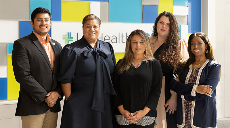 UI Health staff members pose inside the hospital's atrium