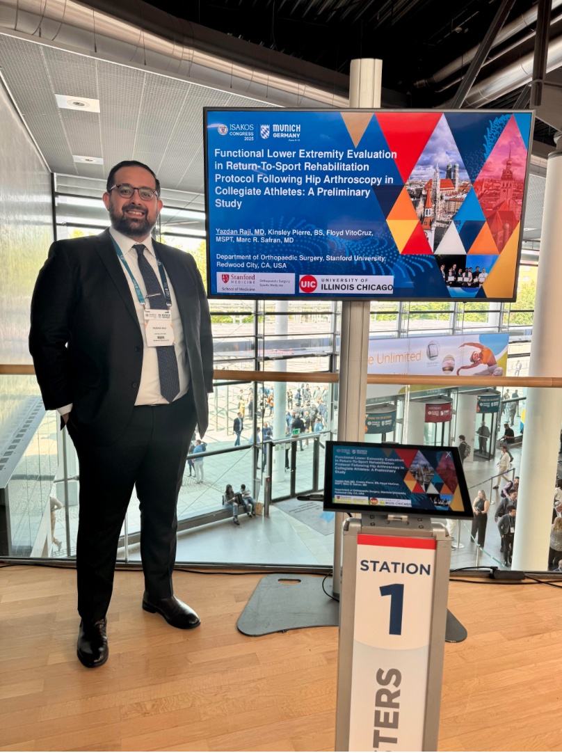 A man standing next to a posterboard
